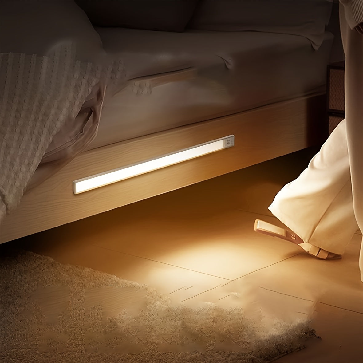 Rechargeable LED light bar with motion sensor, ideal for kitchen cabinets and wardrobes.